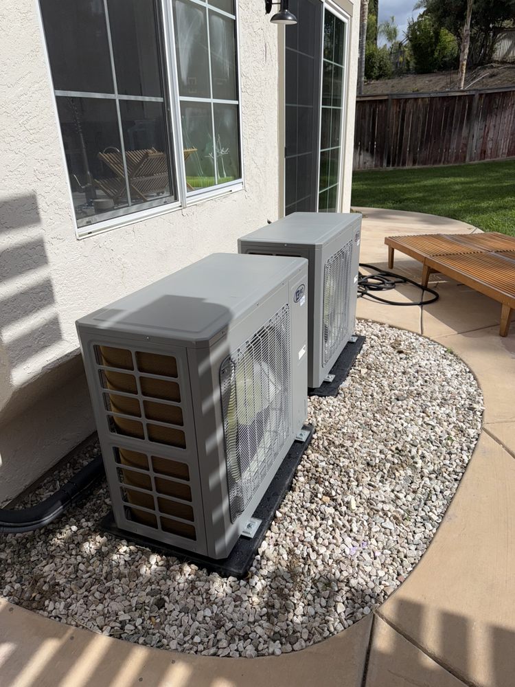 Two residential air conditioning condenser units installed by Left Coast Air in a backyard